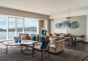 a living room with a couch and chairs and a table at Crowne Plaza Xiamen Jimei Seaview, an IHG Hotel-Free Mini Bar in Xiamen