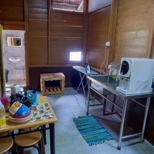 a room with a table with a microwave on it at The Rustique Guest House in Tanah Rata +26 photos
