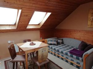 a room with a bed and a table and chairs at Privát Zvonček in Terchová