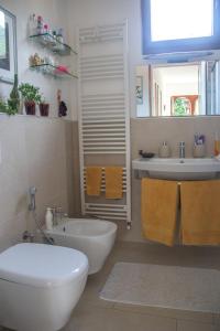 a bathroom with a white toilet and a sink at Villa Michelangelo - WelcHome in Cannobio +15 photos