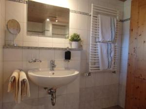 a bathroom with a sink and a mirror at Ferienwohnungen Schwöblehen in Schönau am Königssee