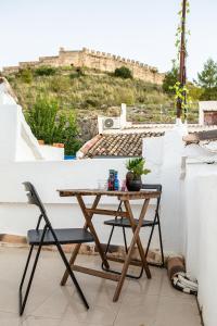a table and a chair on a balcony at Fortress Jacuzzi Suites in Xàtiva
