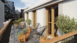 a balcony with chairs and tables and potted plants at La Gallega by Upper Luxury Housing in A Coruña