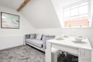 a living room with a white table and a couch at Guest Homes - New Street Dwelling in Worcester