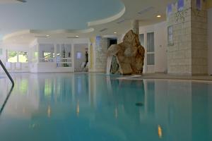 an empty swimming pool with a rock in the middle of it at Hotel Seeber in Racines