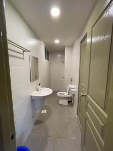 a bathroom with a sink and a toilet and a door at Paradise Penthouse 5 bedrooms 5 bathrooms in Tanah Rata
