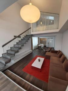 a living room with a couch and a table at Apart Hotel Vlad Tepes in Braşov