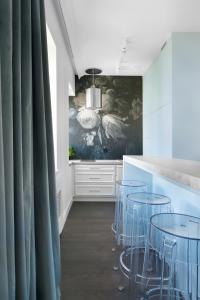 a kitchen with blue chairs and a counter at Elite Apartments Old Town Deluxe in Gdańsk