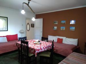 a dining room with a table with a red and white table cloth at Departamento turista in Mendoza
