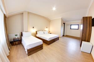 Giường trong phòng chung tại Sina Hotel