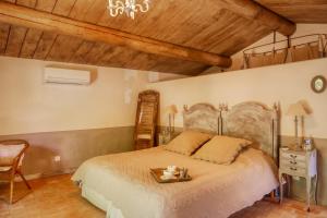 a bedroom with a bed with a tray on it at Mas en Baronnies Provençales in Eygaliers