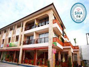 a building with a sign in front of it at The Orchid House - SHA Extra Plus in Kata Beach