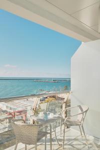 a balcony with chairs and a view of the beach at "Serenity Premium apartments" с панорамным видом на море in Sochi