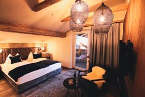 a bedroom with a bed and a window and lights at SOULSISTERS' Hotel 4 Sterne Superior in Kaprun