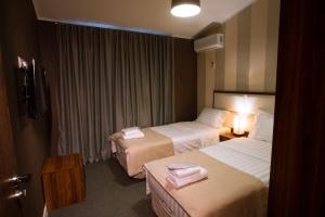 Un pat sau paturi într-o cameră la Hotel West