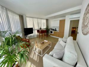 a living room with a couch and a table at Hotel Emblemático Hi Suites in Santa Cruz de Tenerife