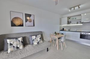 a living room with a couch and a table at Costa Isora in Puerto de Santiago