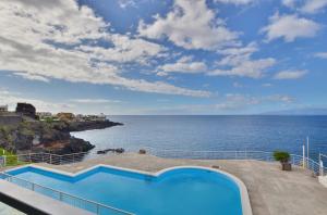 a swimming pool with a view of the ocean at Costa Isora in Puerto de Santiago