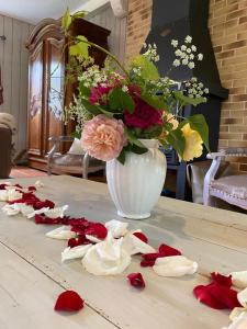 a vase with a bouquet of flowers on a table at Gite De Saba in La Celle-Condé