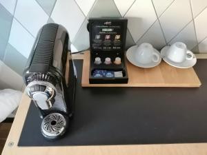 a black blender sitting on a table next to dishes at Bruderherz in Nuremberg