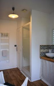 a bathroom with a glass shower and a sink at Gite De Saba in La Celle-Condé