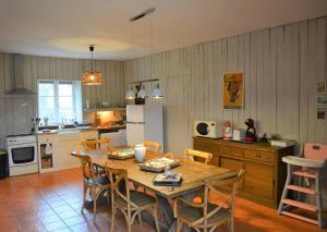 a kitchen with a wooden table and chairs in a room at Gite De Saba in La Celle-Condé