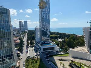 an aerial view of a city with a tall building at Apartment In Porta Batumi Tower in Batumi