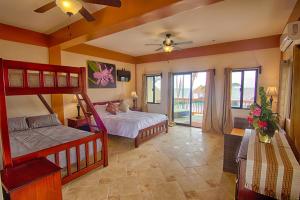 a bedroom with two bunk beds and a balcony at Beaches and Dreams Boutique Hotel in Hopkins