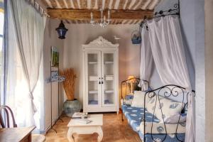 a bedroom with a bed and a table and a window at Mas en Baronnies Provençales in Eygaliers
