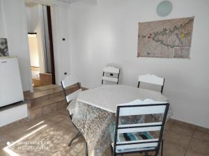 a table and chairs in a room with a map on the wall at Le Dimore Di Gianni in Favignana