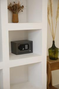 a microwave on a shelf in a white wall at Studio Toro in El Chalten