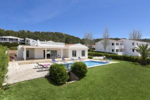 a house with a swimming pool and a yard at Villa Lola in Santo Tomás