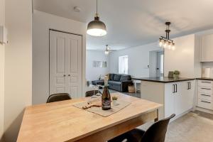 a kitchen and a table with a bottle of wine on it at Le Royale - Havre de paix in Quebec City +21 photos