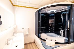 a bathroom with a tub and a large mirror at Appartement Maison de L'Église du Couvent in Narbonne +25 photos