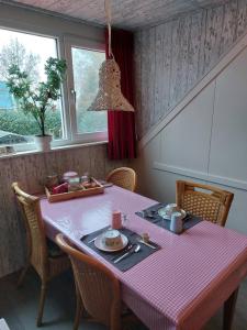 a dining room table with a pink checkered table cloth at B&B Nieuwleusen in Nieuwleusen