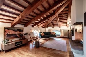 a living room with wooden ceilings and wooden floors at Salorino Apartments by Quokka 360 - Quiet Escape with Panoramic Nature Views in Mendrisio