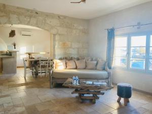 a living room with a couch and a table at Manade des Baumelles in Saintes-Maries-de-la-Mer