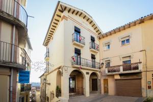 a building with an arch in a street at Cal Marti de Gironella in Gironella