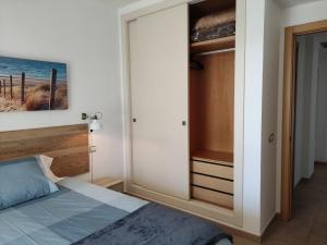 a bedroom with a bed and a sliding glass door at APARTMENT LA CALA DESIGN & ALAMAR SEA WIEW. in La Cala de Mijas