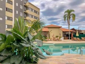 a view of a hotel with a swimming pool at PALMEIRAS A14 in Ubatuba
