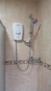 a shower with a shower head in a bathroom at Portobello House - Four Bedroom House perfect for CONTRACTORS - Sleeps 6 - FREE parking in Wolverhampton