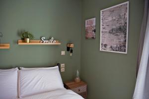 een slaapkamer met een bed en een plank aan de muur bij Lake room in Ioannina