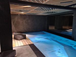 a swimming pool in a room with a ceiling at Domki PRemium in Zawoja