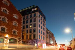 a tall building on a city street at night at REZz Cork in Cork
