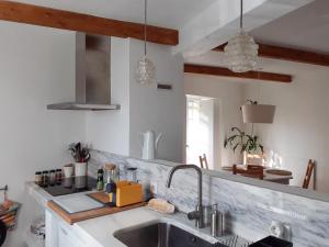 a kitchen with a sink and a counter top at Casa da Bica d'Água in Óbidos