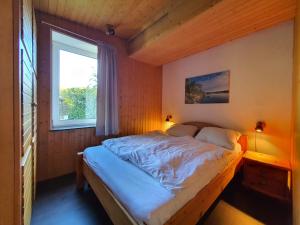 Postel nebo postele na pokoji v ubytování Ferienhaus am Südhang der Bentheimer Berge nah an der Natur + 13 fotografií