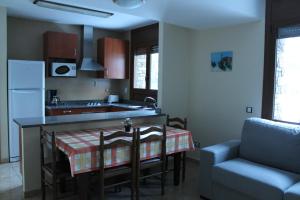 a kitchen with a table with a table cloth on it at Apartaments Vilaró in Llorts
