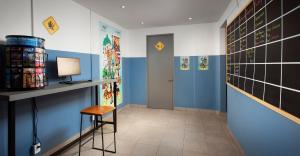 a hallway with blue walls and a desk and a chair at Hostal CASA MX centro in Mexico City +25 photos