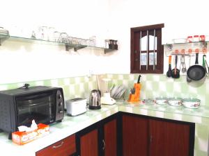 a kitchen with a microwave and a counter top at Mango Villa in Hikkaduwa