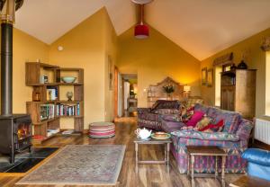 a living room with a couch and a fireplace at Finest Retreats - The Dairyhouse in Church Stoke